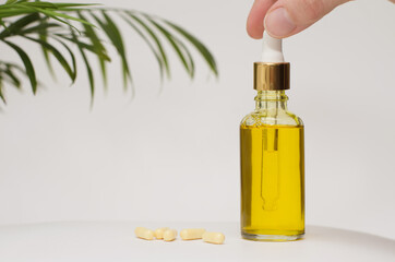 clear yellow bottle soft light background. Protector skin Treatment facial essence oil, Vitamin C. Beauty and spa Concept. Collagen