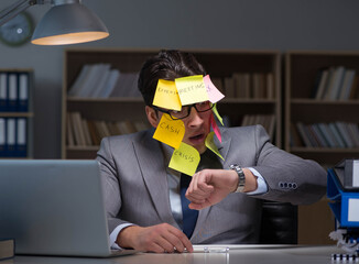 Businessman staying late to sort out priorities