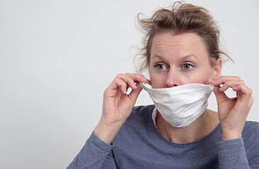 woman with face mask protecting herself from coronavirus on white background stock photo