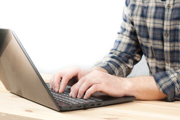 Man's hands are typing on a laptop. Online shopping