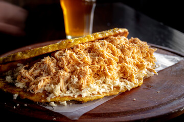 Venezuelan cachapa with cheese and a glass of beer