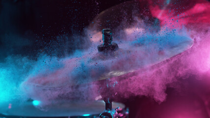 Freeze motion of coloured powder explosion on drum cymbal - obrazy, fototapety, plakaty