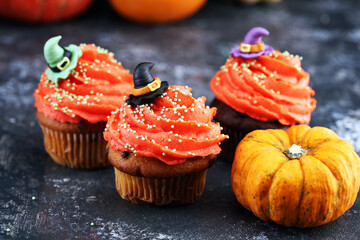 halloween cupcake and pumpkin on a dark background. sweets with cupcakes for the celebration of spooky Halloween.