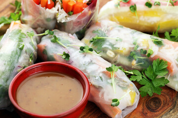 Fried chinese spring rolls with sweet chili sauce on rustic background