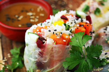Fried chinese spring rolls with sweet chili sauce on rustic background