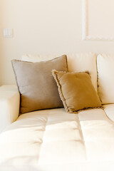 Beautiful luxury pillow on sofa decoration in livingroom interior Light brown and beige colors