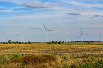 Wind turbines at the agricultural field. Clean energy. Ecological concept