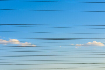 High voltage power line wires against the sky