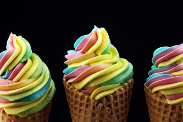 Vanilla frozen yogurt or rainbow soft ice cream in waffle cone