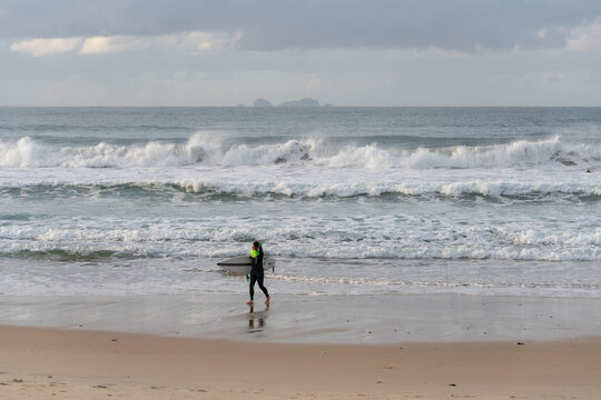 Surfers surfing in Baleal Island beach atlantic ocean waves in Peniche, Portugal