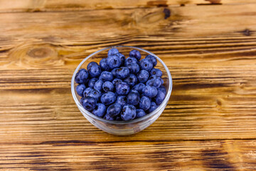 Blueberry in glass bowl on a wooden table