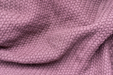 Fototapeta na wymiar Crumpled pink woolen fabric texture background.