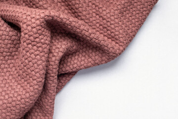 Crumpled brown woolen fabric on white background.