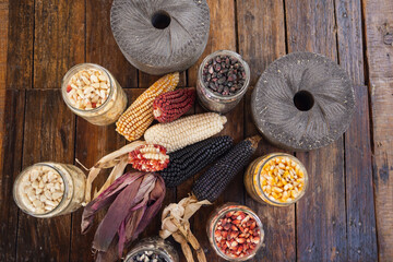 Different species and colors of corn on wooden table. Corn for tortillas on wooden table. Mexican food.