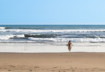 lonely and thoughtful man watching the waves the sky and horizon on the shore of the beach