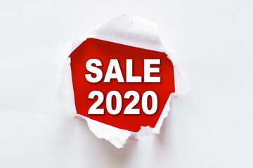White torn paper with a word SALE 2020