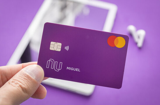 Sao Paulo/SP/Brasil - 24/08/2020: Nubank Card with tablet and earphones on background - Selective Focus