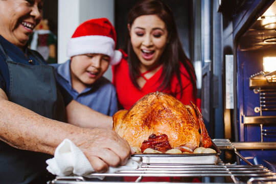 Latin family happy roasting Christmas eve turkey in Mexico