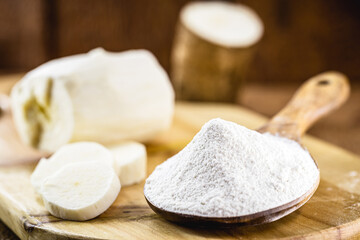 wooden spoon with manioc flour. Root used in Brazilian cuisine, called macaxeira, cassava, castelinha, uaipi, sweet cassava, maniva, maniveira and poor bread.