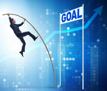 Businessman pole vaulting towards his goal in business concept