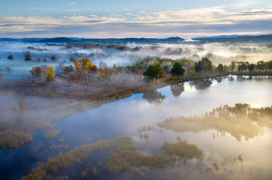 Beautiful aerial view of morning fog and sunrise in autumn forest.