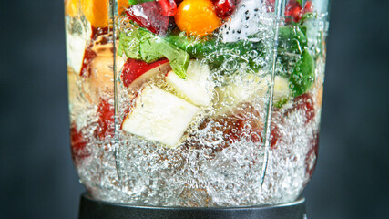 Fresh fruit and vegetables smoothie blended in blender, back view. Healthy eating concept.