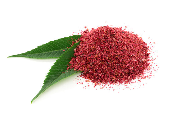 Ground Sumac Powder Spice with Leaves. Isolated on White Background.