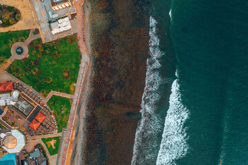 Aerial view of rocky beach by the Atlantic ocean on a windy day in summer