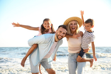 Happy family on beach near sea. Summer vacation - Powered by Adobe