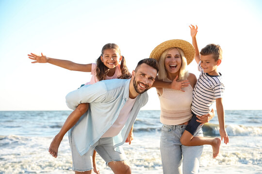 Happy family on beach near sea. Summer vacation