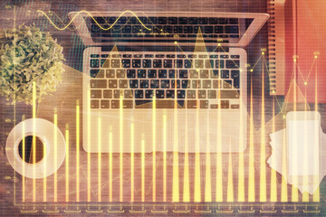 Stock market chart and top view computer on the table background. Multi exposure. Concept of financial analysis.