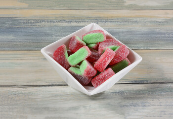 Sour watermelon gummy candy in white candy dish on table