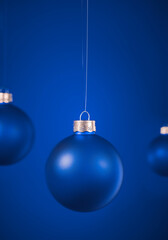 Light blue round matt Christmas ball. Christmas ornament standing on blue background.