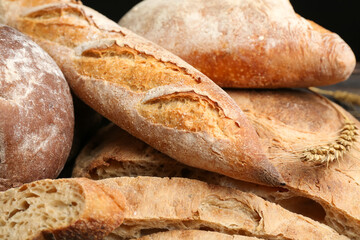 Different kinds of fresh bread as background, closeup