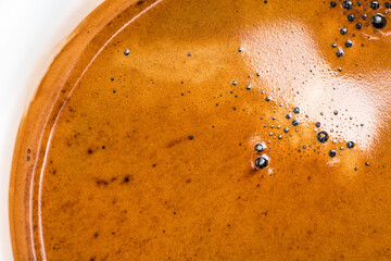 Golden espresso coffee crema texture. Speciality coffee  extraction concept.