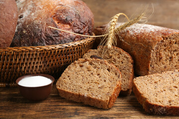 Tasty freshly baked bread on wooden table
