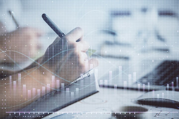 Double exposure of forex graph drawing over people taking notes background. Concept of financial analysis