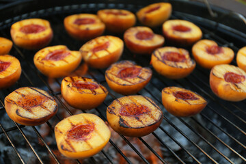 Modern grill with tasty cut peaches, closeup