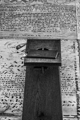 psalm book on a wooden bench upon an ancient gravestone in church