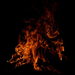 the face of a demon emerges from the flames
