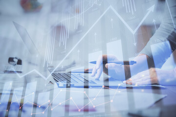 Multi exposure of woman hands typing on computer and financial chart hologram drawing. Stock market...