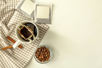 Flat lay composition with drip coffee on white table. Space for text