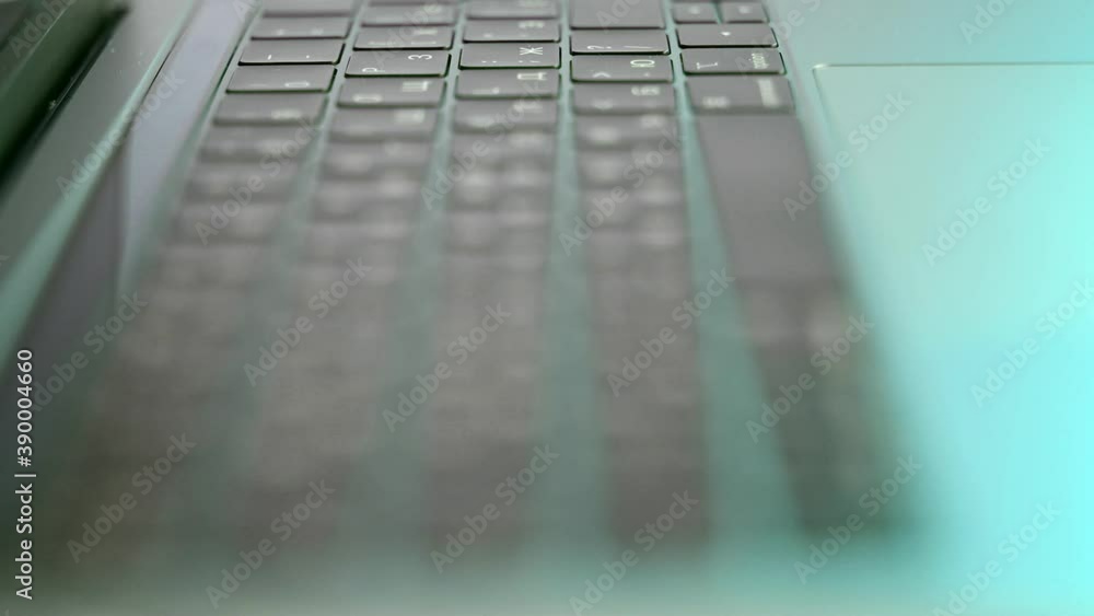 Poster side view of laptop or computer details, black keyboard with white symbols. action. extreme close up