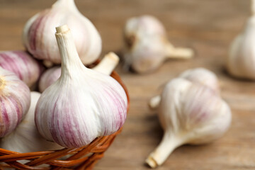 Fresh organic garlic in wicker basket, closeup