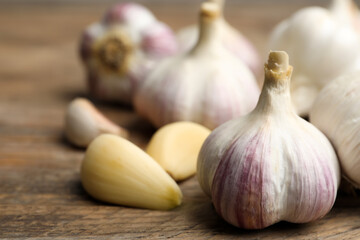 Fresh organic garlic on wooden table, closeup