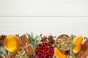 Flat lay composition with mulled wine ingredients on white wooden table. Space for text