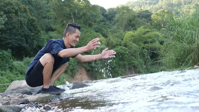 Close-up hands business man   touching water in  nature and life concept