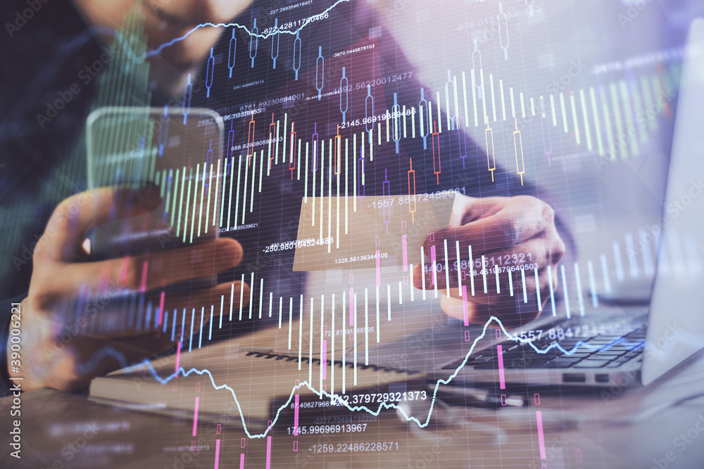 Wall mural double exposure of man's hands holding and using a phone and financial graph drawing. analysis conce