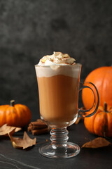 Delicious pumpkin latte on black slate table, closeup