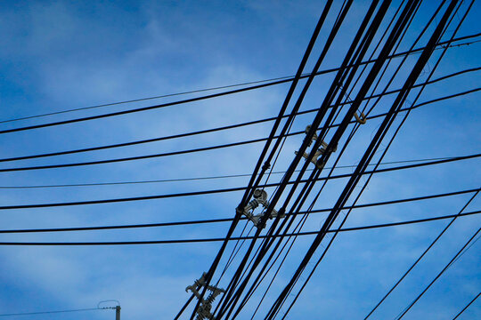 The electric cable has a sky in the background.
